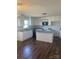 Modern kitchen with white cabinetry, granite countertops and hardwood flooring at 9450 Paul Payne Store Rd, Stony Point, NC 28678