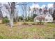Large grassy backyard with a utility shed and various garden features and plants at 9534 Markus Dr, Mint Hill, NC 28227