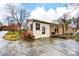 Side view of home, showcasing the back entrance, patio, and a fenced yard with trees in the background at 9534 Markus Dr, Mint Hill, NC 28227