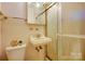 Bathroom with toilet, sink, cabinet, and shower with frosted doors at 9534 Markus Dr, Mint Hill, NC 28227