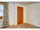 Cozy bedroom with neutral carpet, classic wood door, and floral curtains for a warm ambiance at 9534 Markus Dr, Mint Hill, NC 28227