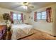 Comfortable bedroom with two bright windows and floral patterned bedding and decor at 9534 Markus Dr, Mint Hill, NC 28227