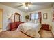 Cozy bedroom featuring a bed with patterned bedding and a dark wood dresser at 9534 Markus Dr, Mint Hill, NC 28227