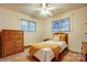 Bright bedroom with two windows, bed, dresser, and ceiling fan at 9534 Markus Dr, Mint Hill, NC 28227