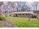 Charming brick home with a well-maintained yard and mature trees, creating a serene setting at 9534 Markus Dr, Mint Hill, NC 28227