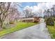 A charming brick home with a long driveway, a detached garage, and mature trees at 9534 Markus Dr, Mint Hill, NC 28227