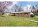 Charming brick home with a well-maintained yard and mature trees, creating a serene setting at 9534 Markus Dr, Mint Hill, NC 28227