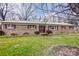 Charming brick home with well-manicured lawn, featuring burgundy shutters and mature landscaping at 9534 Markus Dr, Mint Hill, NC 28227