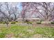 Quaint brick home with mature trees, flowering magnolias, and lush green lawn at 9534 Markus Dr, Mint Hill, NC 28227
