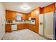 Functional kitchen with wood cabinets, white appliances, and linoleum flooring at 9534 Markus Dr, Mint Hill, NC 28227