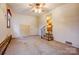 View of living room featuring wood-trim window, white door and staircase at 9534 Markus Dr, Mint Hill, NC 28227