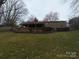 A large backyard with mature trees and a deck perfect for relaxing or entertaining at 100 Chadmore Dr, Charlotte, NC 28270