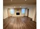 Spacious basement area with hardwood floors and a brick fireplace at 100 Chadmore Dr, Charlotte, NC 28270