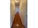 Hallway featuring hardwood floors, white trim, and multiple doorways at 100 Chadmore Dr, Charlotte, NC 28270