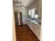 Bright kitchen features white cabinets, stainless steel appliances, and wood flooring at 100 Chadmore Dr, Charlotte, NC 28270