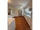 Bright kitchen featuring white cabinets, stainless appliances, and hardwood floors at 100 Chadmore Dr, Charlotte, NC 28270