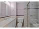 Bathroom featuring a shower with glass doors, tiled walls, vanity, and toilet at 10405 Club Car Ct, Mint Hill, NC 28227