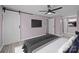 Primary bedroom with a barn door, ceiling fan, tv, and en suite bathroom at 10405 Club Car Ct, Mint Hill, NC 28227