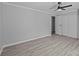 Bedroom featuring light gray walls, a ceiling fan, closet, and LVP flooring at 10405 Club Car Ct, Mint Hill, NC 28227