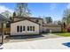 Backyard featuring a patio, pool, grass, and a two-story home on a sunny day at 10405 Club Car Ct, Mint Hill, NC 28227