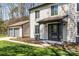 Exterior view of the two-story home, green grass, and a detached garage at 10405 Club Car Ct, Mint Hill, NC 28227