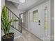 Welcoming foyer features a decorative front door, iron staircase, and natural light at 10405 Club Car Ct, Mint Hill, NC 28227