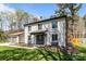 Front yard featuring a two-story home, green grass, blue skies, and a detached garage at 10405 Club Car Ct, Mint Hill, NC 28227