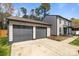 Spacious two-car garage showcasing modern doors and a wide driveway, adjacent to the main house at 10405 Club Car Ct, Mint Hill, NC 28227