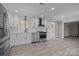 Modern kitchen featuring white cabinets, stainless steel appliances, and an open layout at 10405 Club Car Ct, Mint Hill, NC 28227