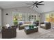 Bright sunroom with vaulted ceilings, stylish furniture, and serene backyard views at 10405 Club Car Ct, Mint Hill, NC 28227