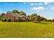 Brick home with a well-maintained lawn and mature trees, offering great curb appeal at 105 Baymount Dr, Statesville, NC 28625