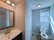 Updated bathroom features modern vanity, mirror, toilet and window at 106 Easy St, Concord, NC 28027