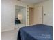 This bedroom features neutral carpeting, wallpaper and sliding mirror closet doors at 109 Joe Teague Rd, Hickory, NC 28601