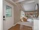 Bright living room featuring a large window, built-in shelving, and hardwood floors at 109 Joe Teague Rd, Hickory, NC 28601