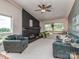 Cozy living room featuring a black brick fireplace, ceiling fan, and comfortable seating at 109 Joe Teague Rd, Hickory, NC 28601