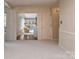 Bright living room showing an open layout with carpet, molding, and an open doorway to a sunroom at 109 Joe Teague Rd, Hickory, NC 28601