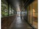 Covered porch with brick wall and an outdoor sitting area with chairs at 109 Joe Teague Rd, Hickory, NC 28601