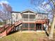 Charming backyard featuring a screened porch, wooden deck and stairway to upper level at 10940 Wild Dove Ln, Charlotte, NC 28277