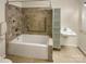 Bathroom with tiled shower, grab bars, white sink and cabinet for accessibility and style at 10940 Wild Dove Ln, Charlotte, NC 28277