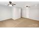 Expansive bedroom with carpet flooring, ceiling fans, and neutral walls at 10940 Wild Dove Ln, Charlotte, NC 28277