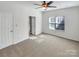 Spacious bedroom with carpet, large window, ceiling fan, and neutral paint, offering a peaceful retreat at 10940 Wild Dove Ln, Charlotte, NC 28277