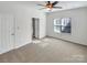 Spacious bedroom with neutral carpet, a ceiling fan, and a bright window at 10940 Wild Dove Ln, Charlotte, NC 28277