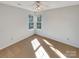 Bright bedroom with neutral carpet, a ceiling fan, and dual windows for ample light at 10940 Wild Dove Ln, Charlotte, NC 28277