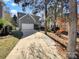 Charming home with a gray exterior, a white garage door, and a long driveway at 10940 Wild Dove Ln, Charlotte, NC 28277