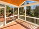 Enclosed porch with wood flooring offering a private outdoor living space at 10940 Wild Dove Ln, Charlotte, NC 28277