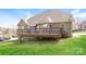 Expansive backyard showcases a large wooden deck and lush lawn under a clear blue sky at 1125 Bugle Ln, Newton, NC 28658