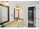 Bright bathroom boasts granite countertop vanities and decorative mirrors in a neutral color scheme at 1125 Bugle Ln, Newton, NC 28658
