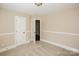 Cozy bedroom features neutral carpet, baseboard trim and an open white door at 1125 Bugle Ln, Newton, NC 28658
