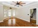 Bright and airy bedroom with hardwood flooring, large ceiling fan, and arch top windows at 1125 Bugle Ln, Newton, NC 28658