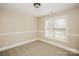 An empty bedroom features carpet, baseboard trim, and a window with blinds, offering a blank canvas at 1125 Bugle Ln, Newton, NC 28658